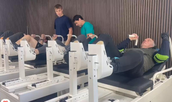 Clients training on our own stroke recovery equipment while trainers watch